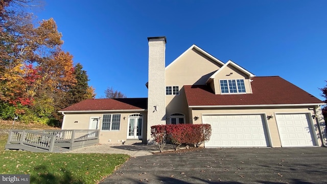 view of front facade featuring a deck and a garage