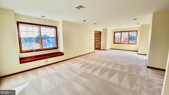 carpeted empty room featuring plenty of natural light