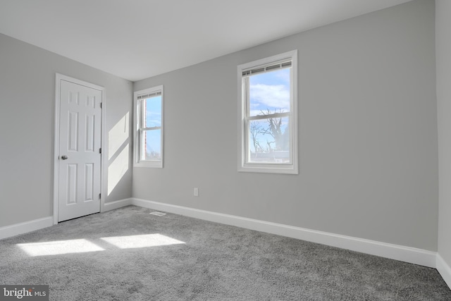 interior space with carpet floors and baseboards