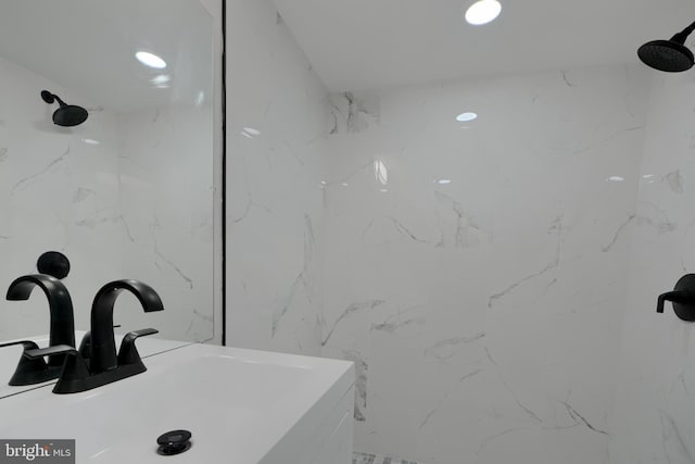 full bath featuring walk in shower, a sink, and recessed lighting