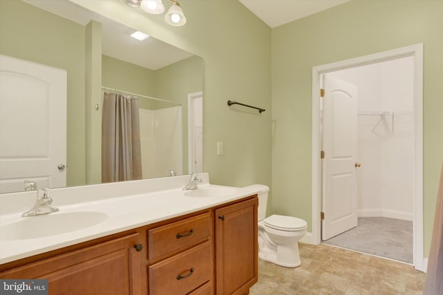 bathroom with vanity, toilet, and walk in shower