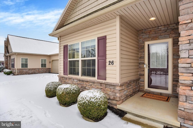 view of snow covered property entrance