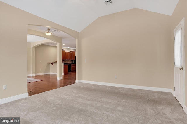 spare room with lofted ceiling and carpet floors