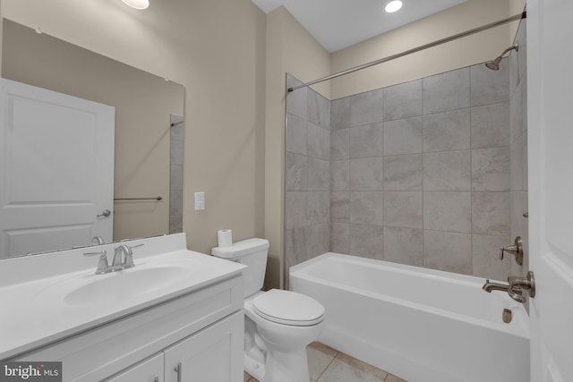 full bathroom with tiled shower / bath combo, vanity, tile patterned floors, and toilet