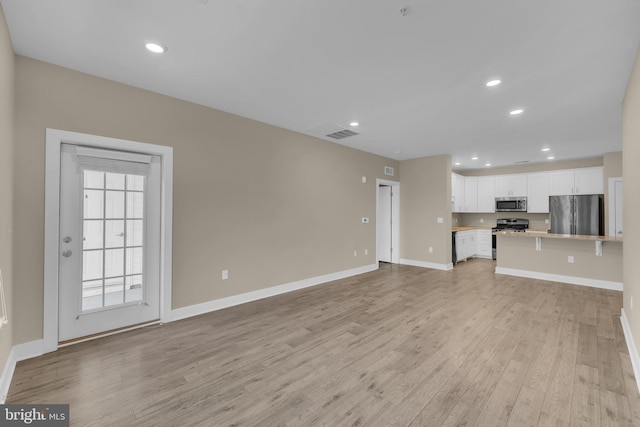 unfurnished living room with light hardwood / wood-style flooring