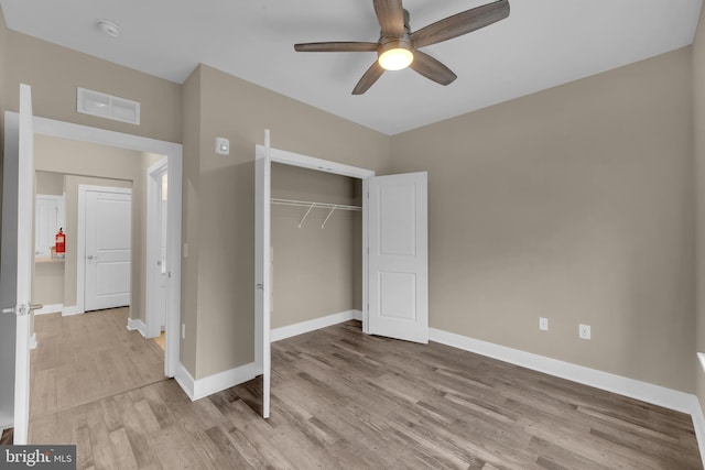 unfurnished bedroom featuring a closet, ceiling fan, and light hardwood / wood-style flooring