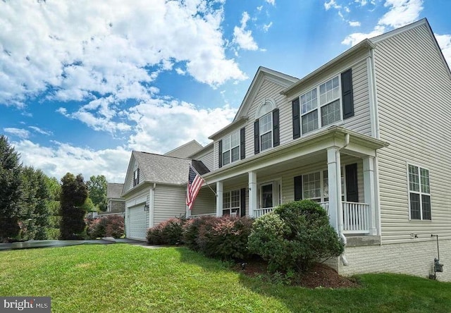 view of home's exterior with driveway, a porch, and a lawn