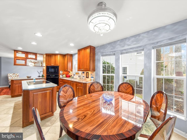 tiled dining room featuring sink