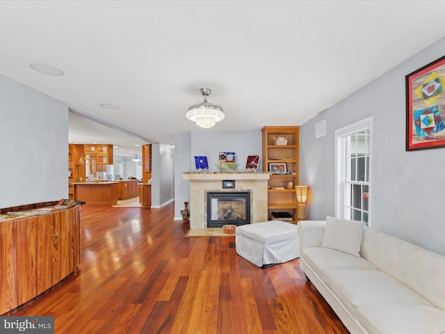 living room featuring a chandelier and hardwood / wood-style floors