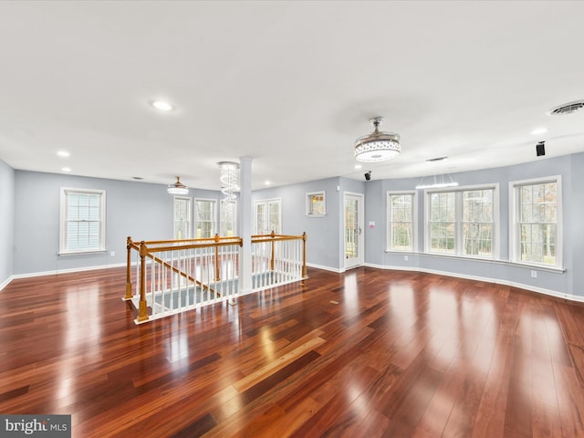 unfurnished room with hardwood / wood-style flooring, ceiling fan, and a healthy amount of sunlight