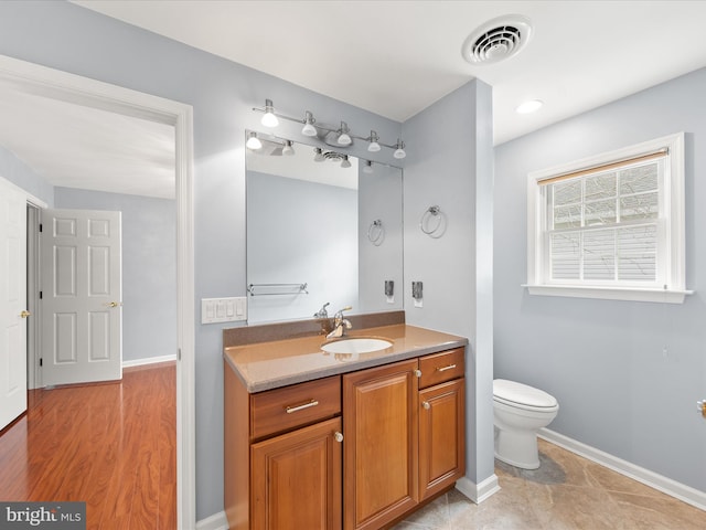 bathroom with vanity and toilet