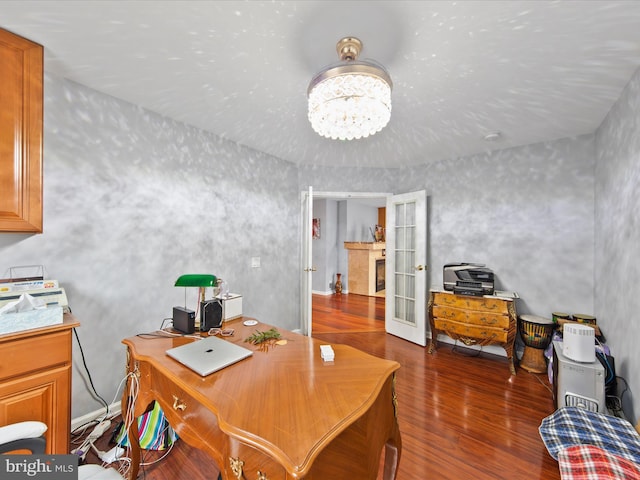 office featuring dark wood-type flooring, a chandelier, and french doors