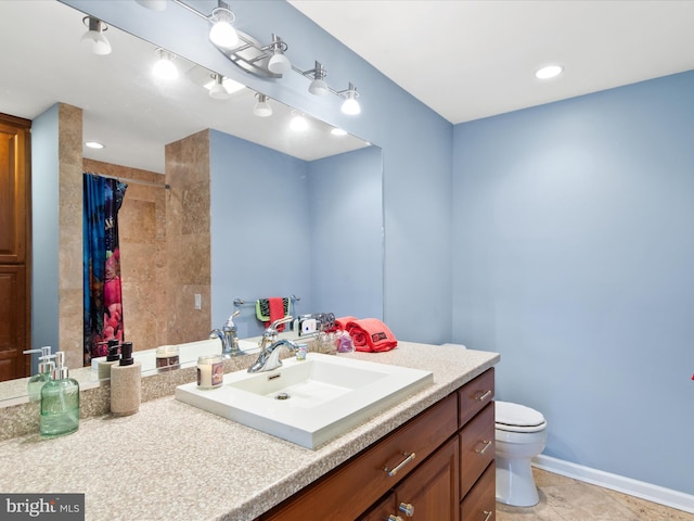 bathroom featuring vanity and toilet