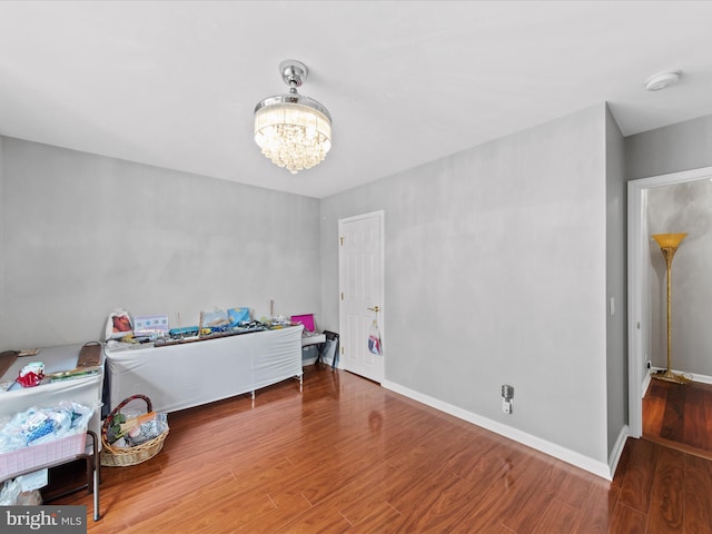 bedroom featuring hardwood / wood-style floors and a chandelier