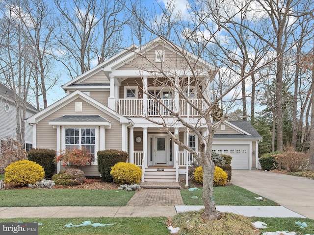 view of front facade featuring a balcony, a garage, and a front lawn