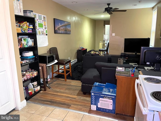 tiled home office featuring ceiling fan