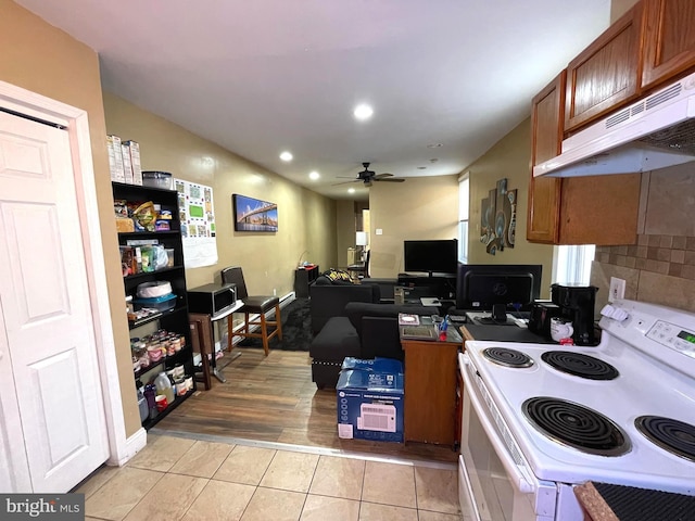 kitchen with light tile patterned floors, electric range, and ceiling fan