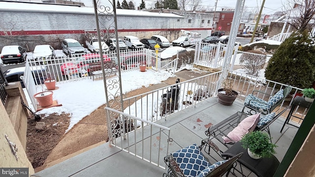 snow covered patio with fence