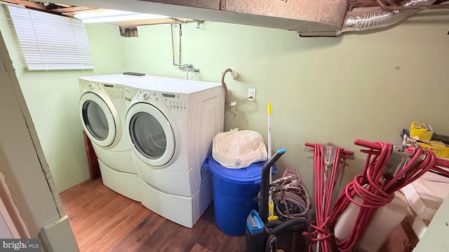 laundry area with wood finished floors and washing machine and clothes dryer