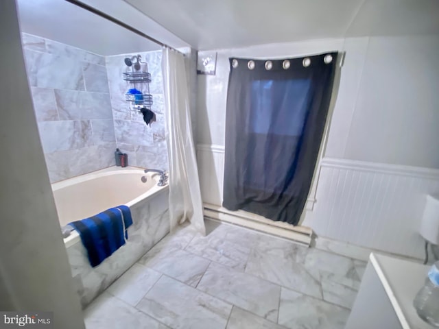 bathroom with a baseboard radiator, a combined bath / shower with marble appearance, and a wainscoted wall