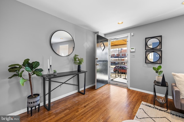 entryway with dark wood-style floors, recessed lighting, and baseboards