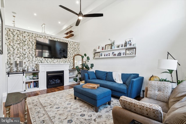 living room featuring hardwood / wood-style flooring, ceiling fan, and lofted ceiling