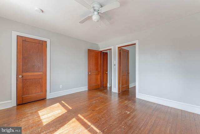 unfurnished bedroom with baseboards and hardwood / wood-style flooring