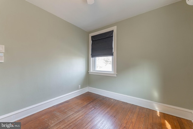 unfurnished room featuring dark wood finished floors and baseboards