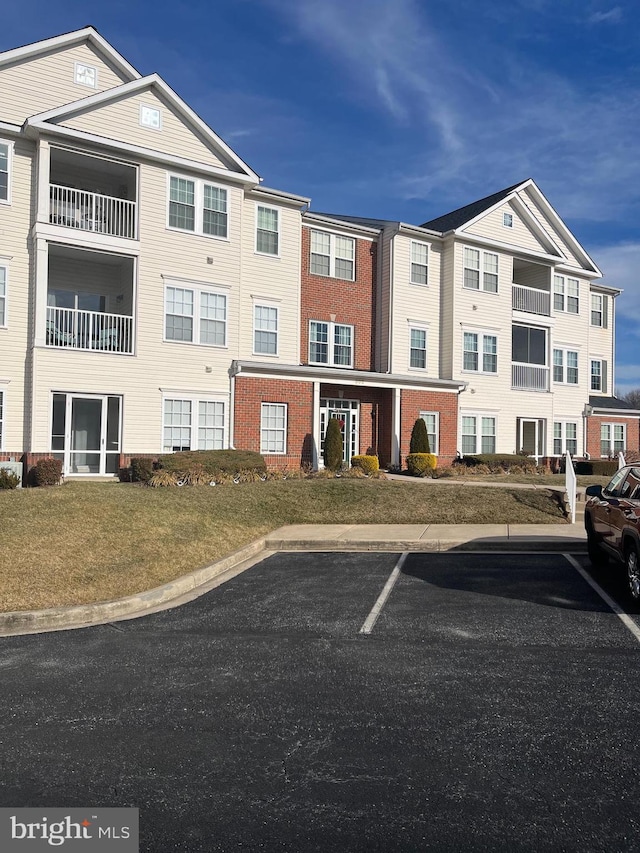 view of building exterior featuring uncovered parking