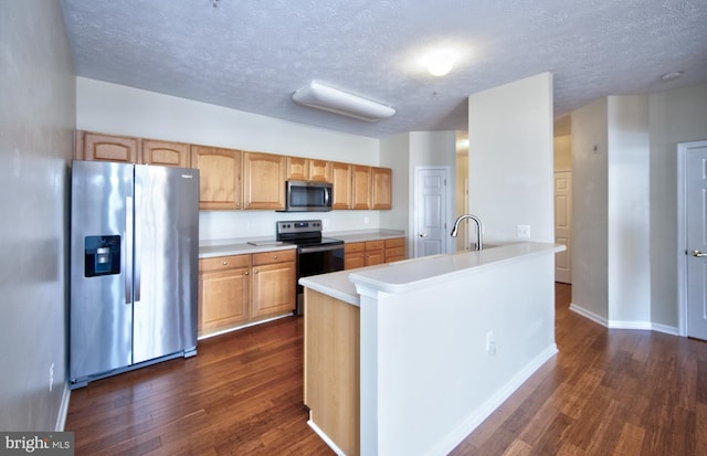 kitchen featuring a textured ceiling, stainless steel appliances, dark wood-style flooring, baseboards, and light countertops