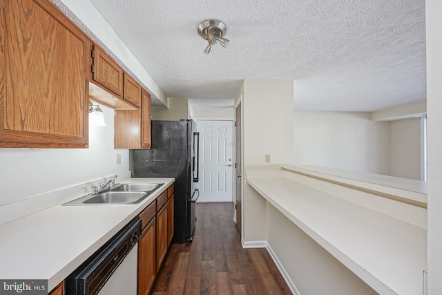 kitchen featuring dark wood-style flooring, light countertops, brown cabinetry, a sink, and dishwashing machine