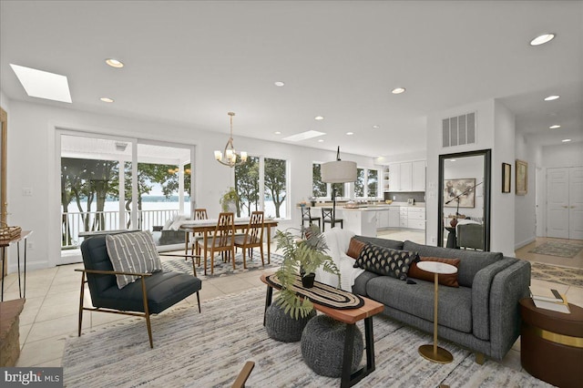 living room featuring light tile patterned floors, visible vents, and recessed lighting