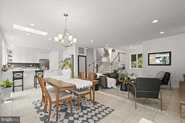 dining room with light tile patterned floors, recessed lighting, a skylight, visible vents, and stairs