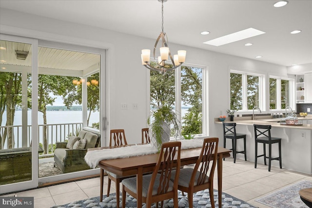 dining room featuring a healthy amount of sunlight, light tile patterned floors, an inviting chandelier, and recessed lighting