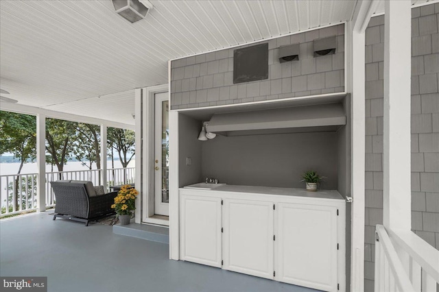 view of patio featuring a porch and a sink