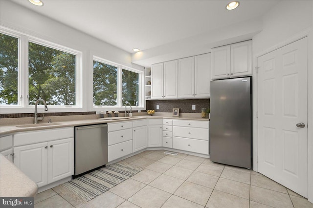 kitchen featuring white cabinetry, appliances with stainless steel finishes, and a sink