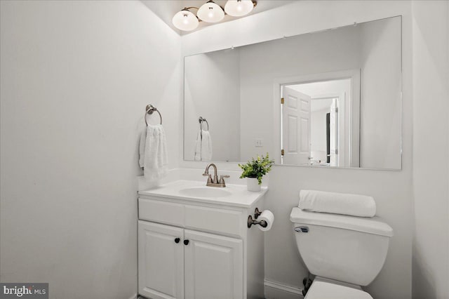 bathroom featuring toilet and vanity