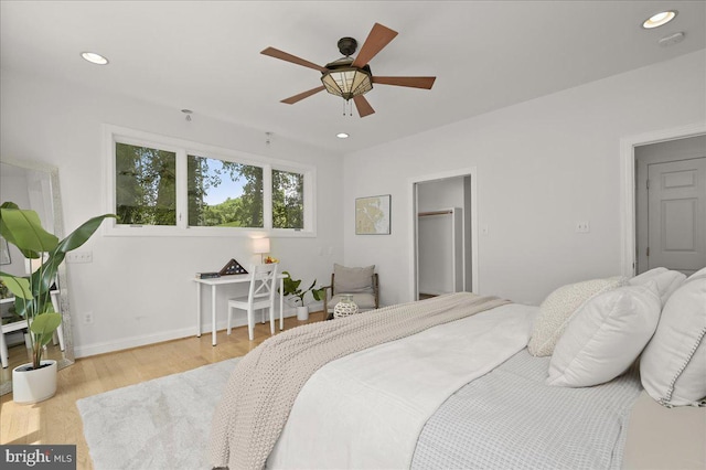 bedroom with baseboards, wood finished floors, a ceiling fan, and recessed lighting