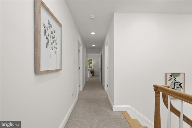 corridor with an upstairs landing, baseboards, light colored carpet, and recessed lighting