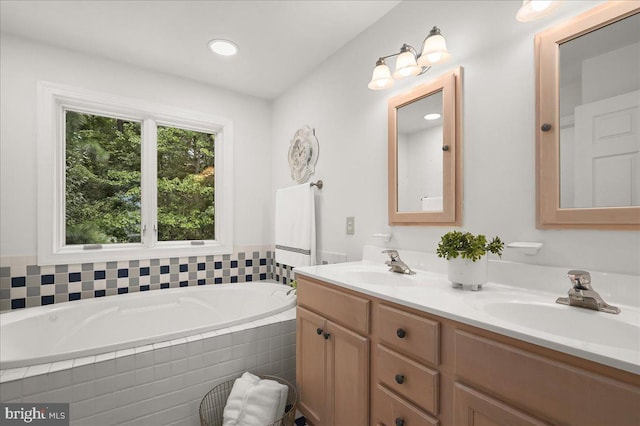 full bathroom with a garden tub, double vanity, and a sink