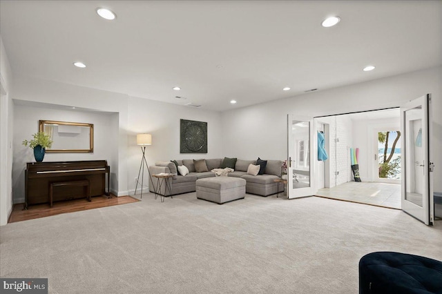 carpeted living area featuring recessed lighting