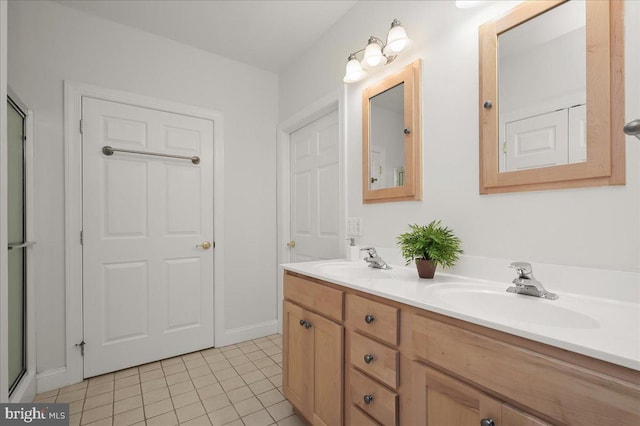 full bathroom featuring double vanity, tile patterned flooring, and a sink