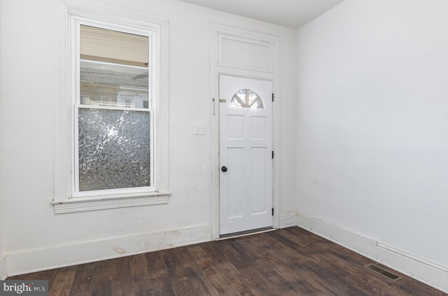 entrance foyer featuring dark wood-type flooring, visible vents, and baseboards