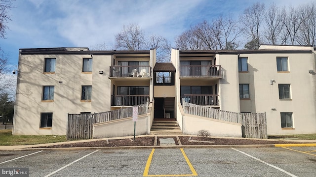 view of building exterior featuring uncovered parking