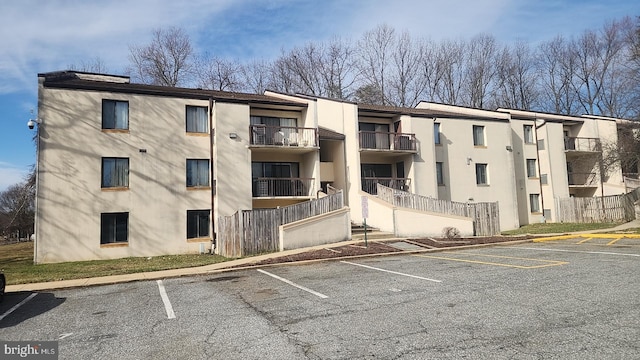 view of building exterior with uncovered parking