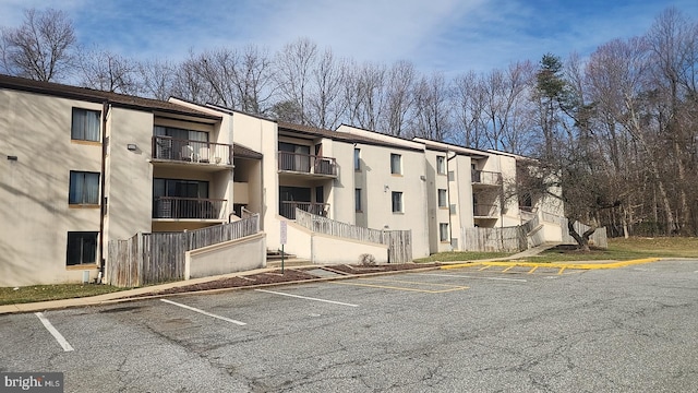 view of building exterior featuring uncovered parking