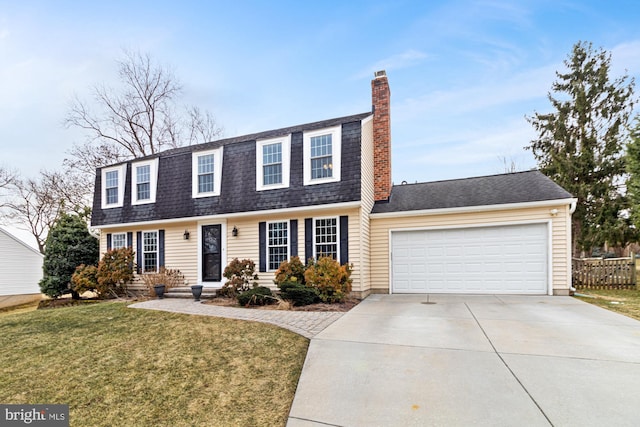 colonial inspired home with a front lawn and a garage