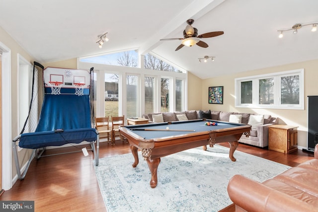 game room featuring hardwood / wood-style flooring, ceiling fan, rail lighting, and lofted ceiling with beams