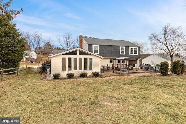 back of property featuring a yard and a deck