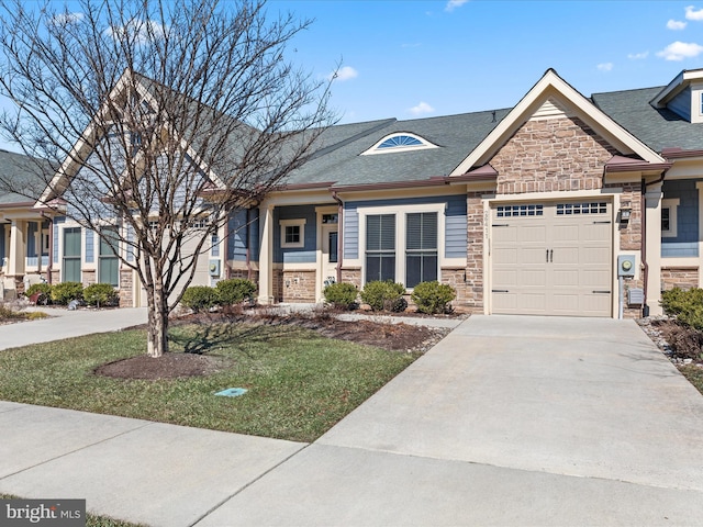 view of front of property with a garage, stone siding, roof with shingles, and driveway